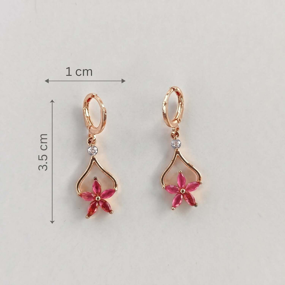 Pink Floral Drop Hoop earrings showcasing a floral design with crystals and gold plating, dimensions 3.5x1 cm.