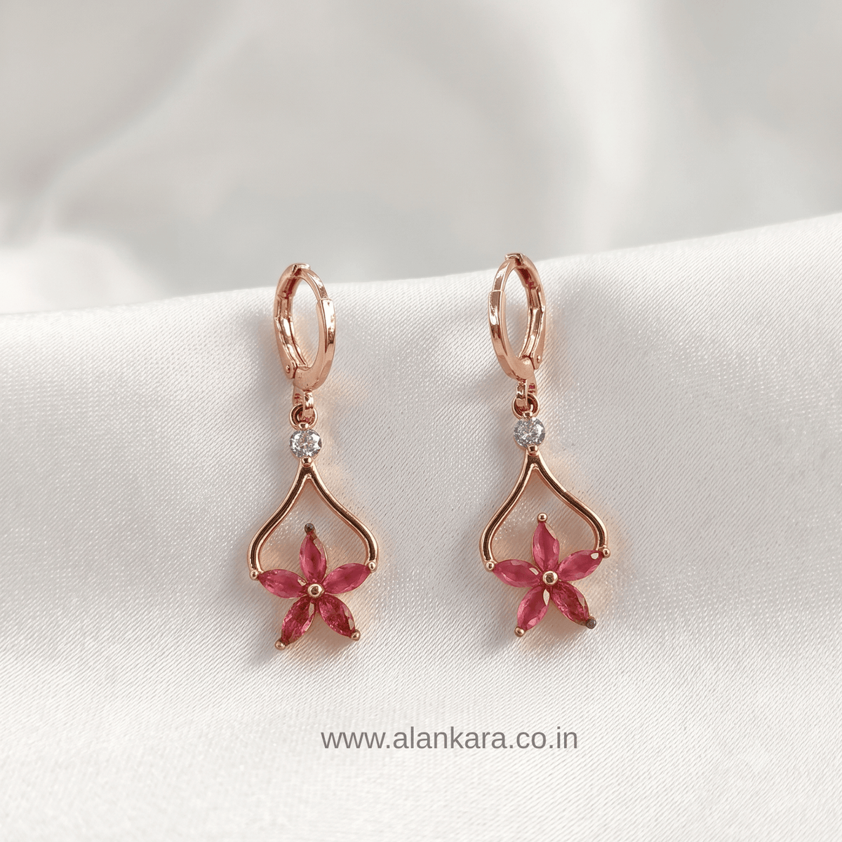 Pink Floral Drop Hoop earrings featuring pink flower design with crystals and gold plating.