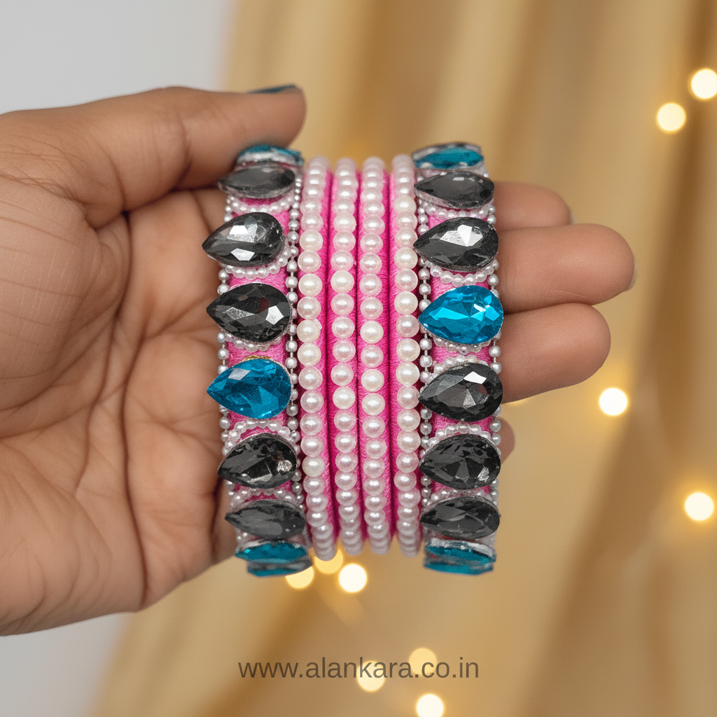 Pink Pearl Crystal Silk Thread Bangles in hand featuring pink silk thread, grey and blue crystals, and white pearls.