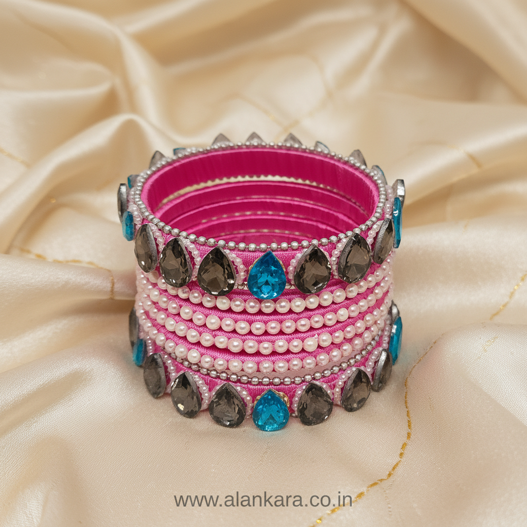 Pink Pearl Crystal Silk Thread Bangles featuring pink silk, pearls, blue and grey crystals, arranged elegantly on silk fabric.