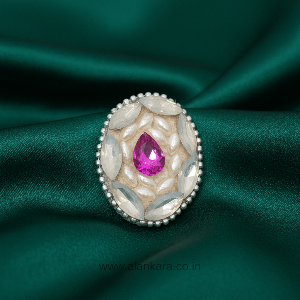 Royal Pink Crystal and Pearl Saree Pin featuring pink crystal and pearl detailing on green fabric.