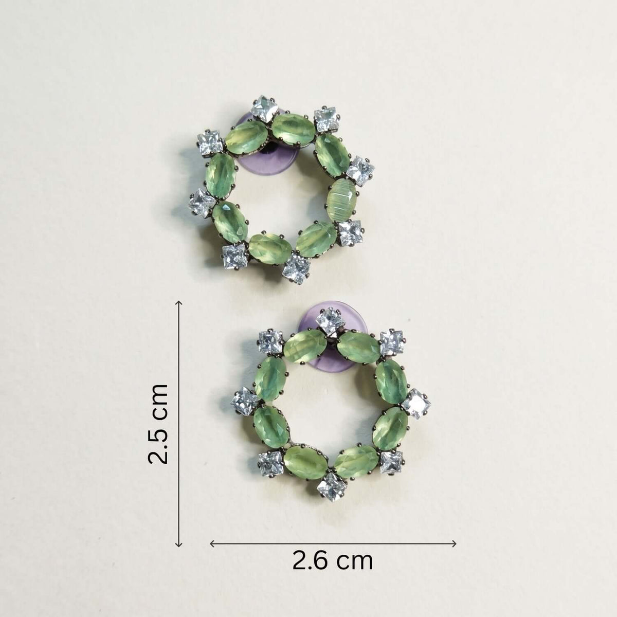Pista Crystal Stud earrings featuring green alloy and stainless-steel design with cubic zirconia stones, dimensions 2.5 cm x 2.6 cm.