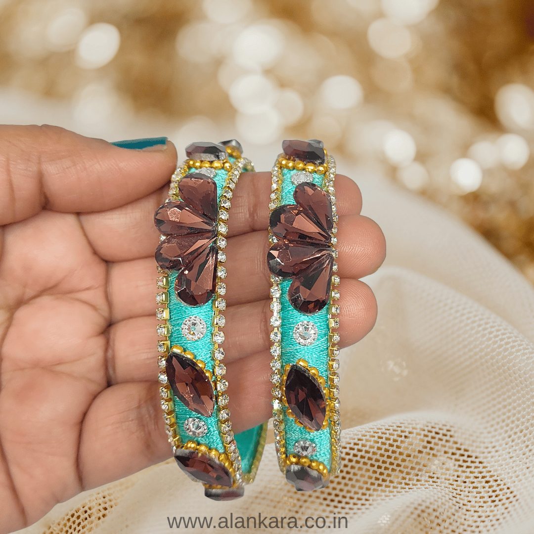 Pista Green Crystal Silk Thread Kada Bangles adorned with wine-colored crystals and golden detailing.