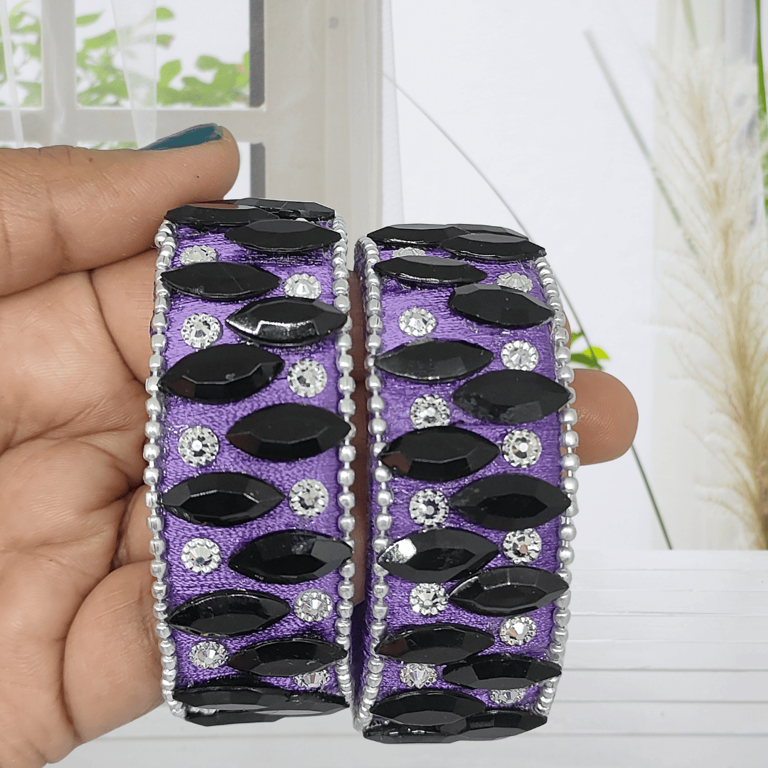 Purple Black Crystal Silk Thread Kada Bangles held in hand, featuring black crystals and white zircon stones on purple silk.