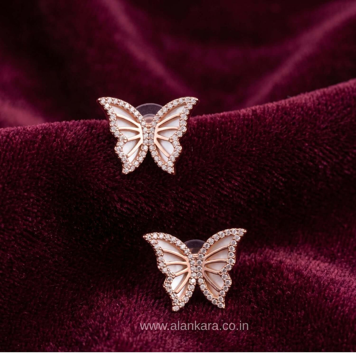 Rosegold Butterfly Stud earrings with cubic zirconia on soft velvet background.
