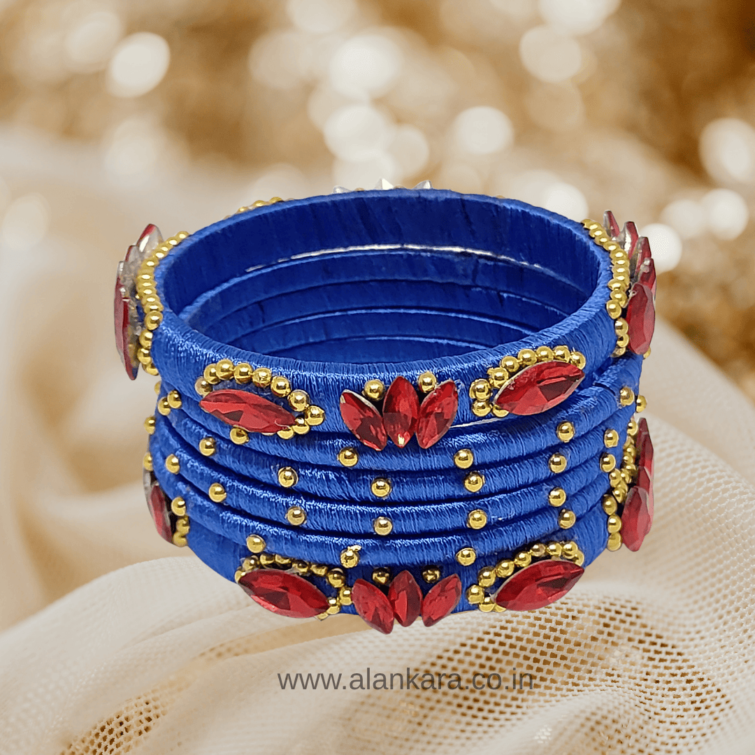 Royal Blue Red crystal silk thread bangles with red crystals and golden beads on a blue silk thread base.