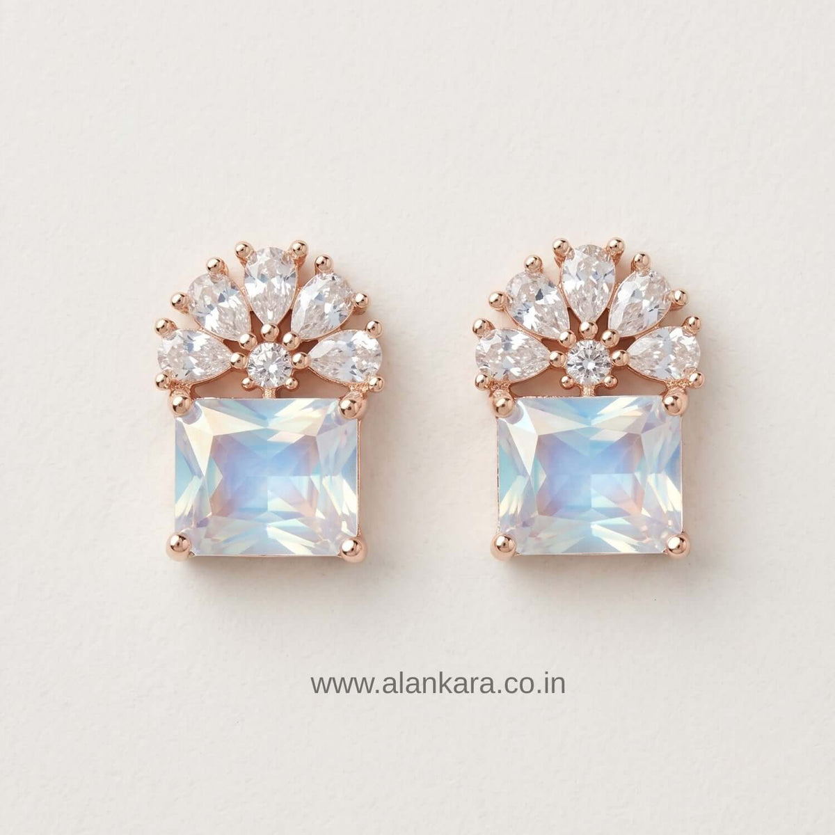 White floral Crystal Stud earrings featuring cubic zirconia stones and rose gold accents.