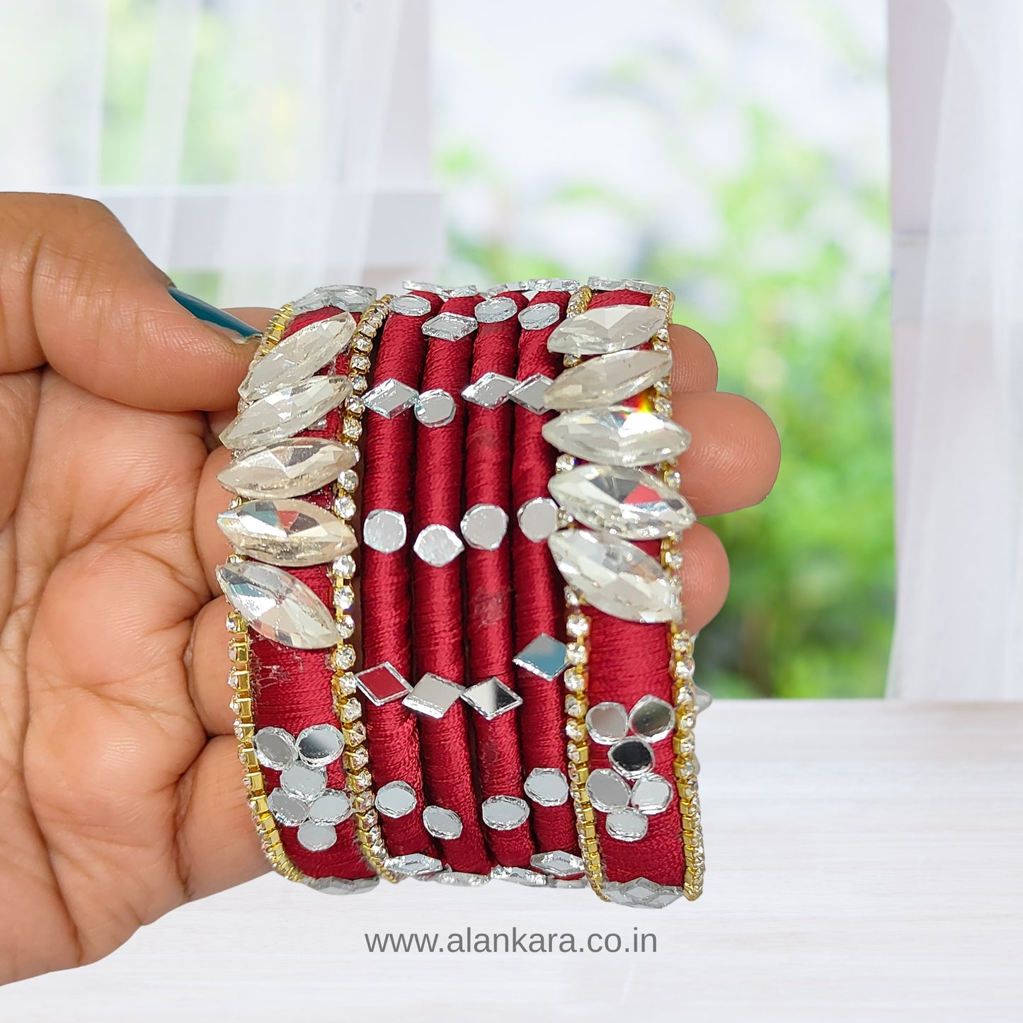 White Crystal Wine Silk Thread Bangles in hand, adorned with white crystals and wine silk thread, creating a luxurious look.