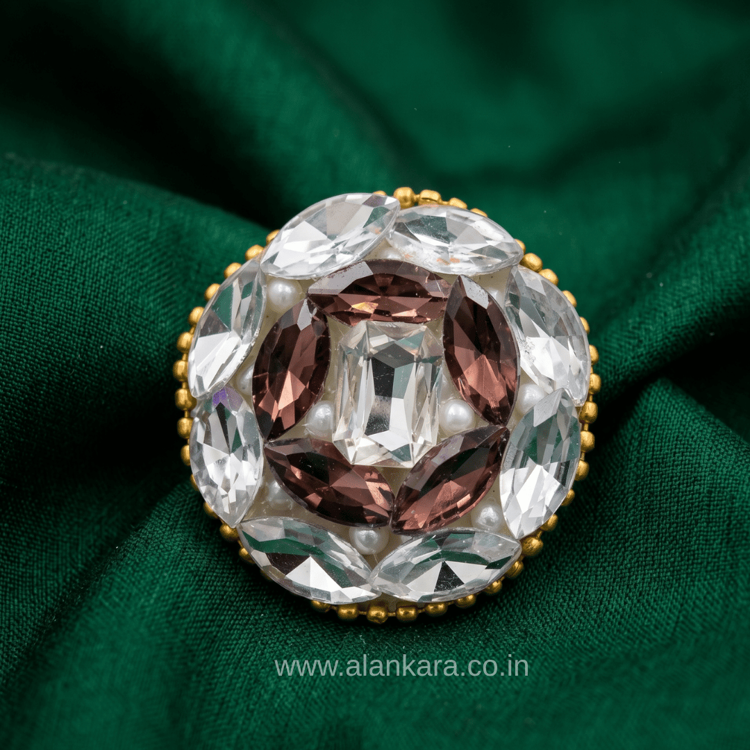 Handmade White & Wine Crystal Pearl Saree Pin featuring sparkling crystals and pearls on a green fabric background.