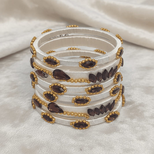 Close-up of White Wine Crystal Silk Thread Bangles with marquise crystals and golden beads, perfect for celebrations.