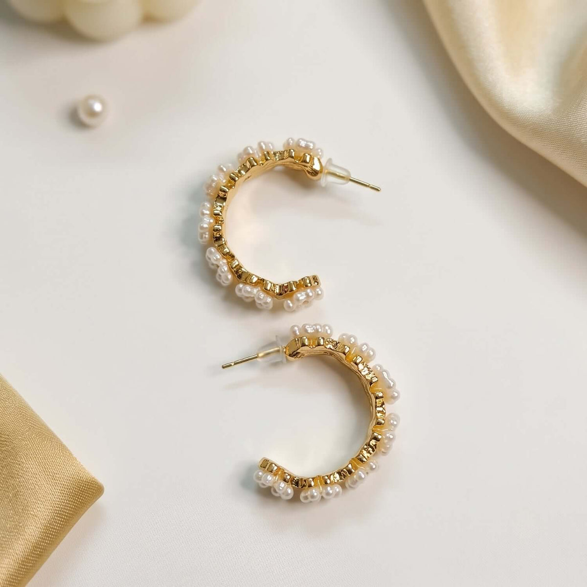 Elegant white golden pearl hoop earrings styled with delicate pearls, perfect for any occasion.