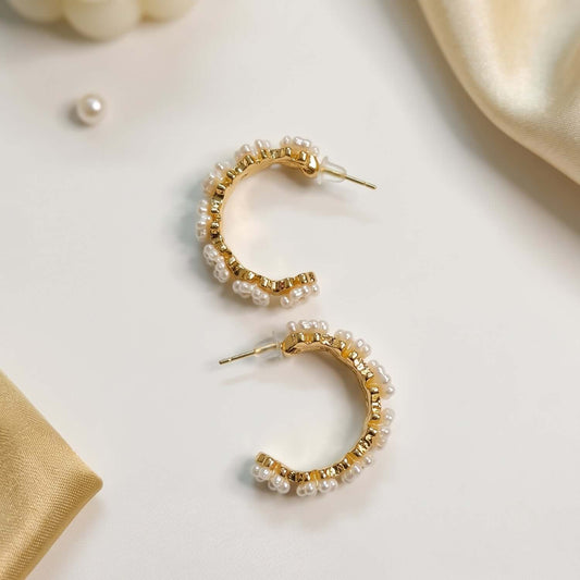 Elegant white golden pearl hoop earrings styled with delicate pearls, perfect for any occasion.