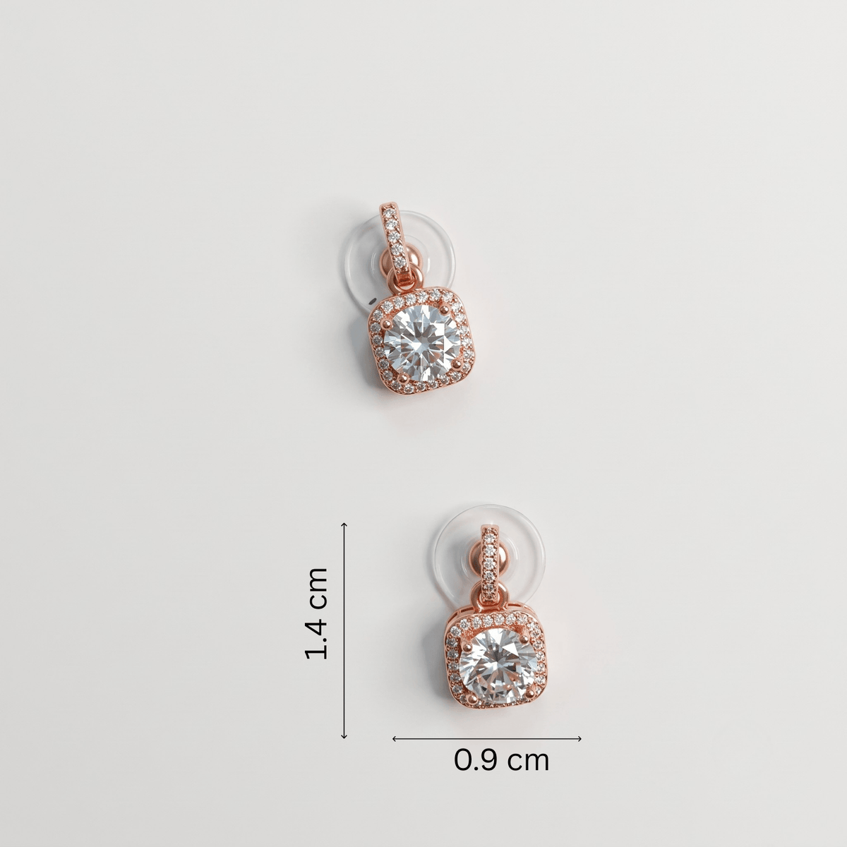 White Rhinestone stud earrings featuring a large cubic zirconia stone with rose gold plating, dimensions 1.4 cm x 0.9 cm.