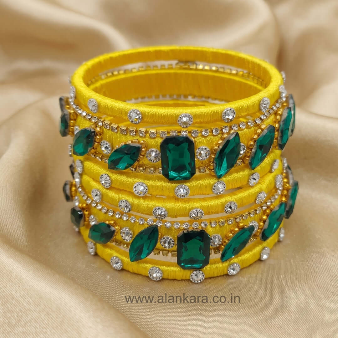 Yellow & Green Noori Silk Thread Bangles with sparkling green crystals and American diamonds, perfect for festive occasions.