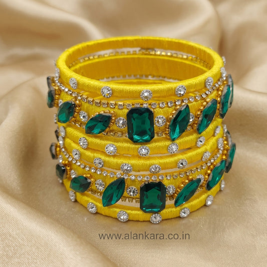 Yellow & Green Noori Silk Thread Bangles with sparkling green crystals and American diamonds, perfect for festive occasions.