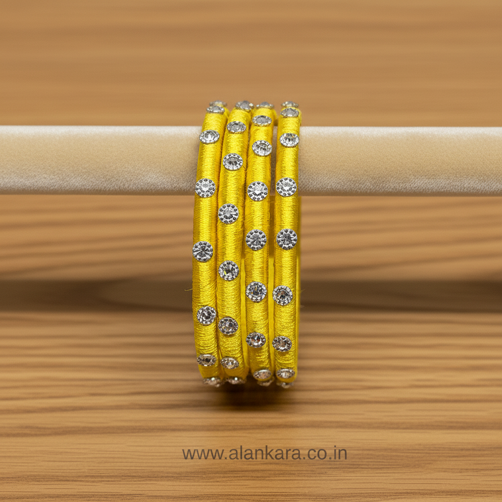Yellow Noori Silk thread bangles featuring vibrant silk finish and shimmering silver embellishments.