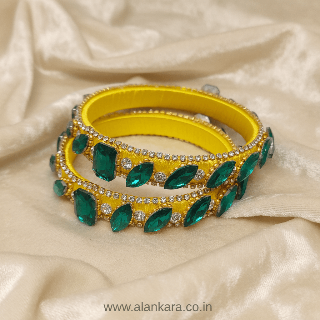 Yellow & Green Noori Silk Thread Kada Bangles with emerald-green stones and crystals on a soft background.